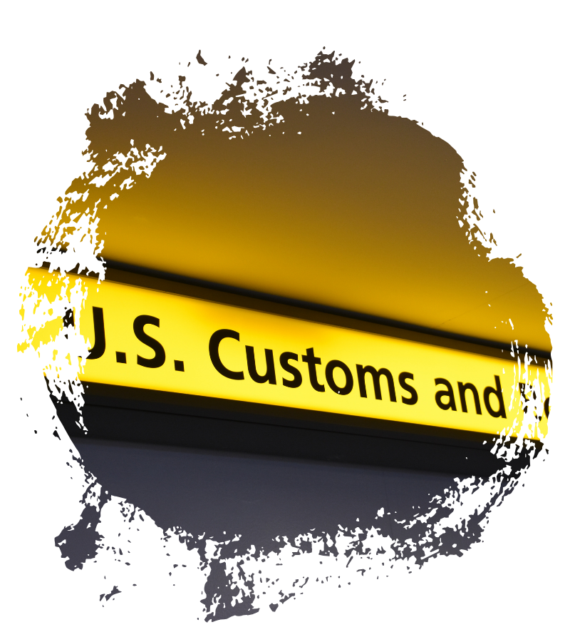 Ein gelb leuchtendes U.S.-Customs-Schild weist auf die Einreisekontrolle an der amerikanischen Grenze hin.