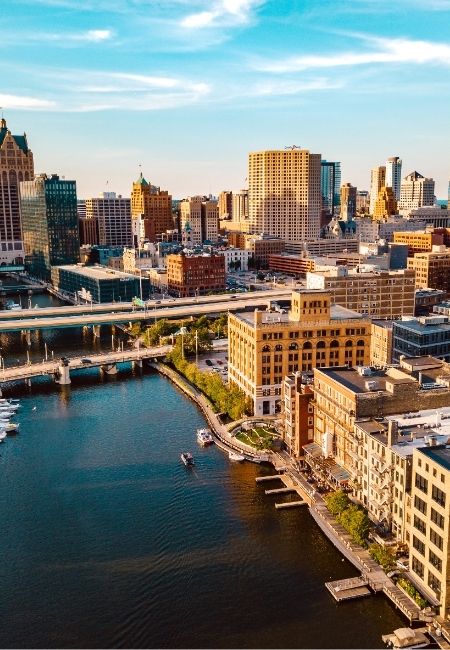 Blick über den Hafen auf die Skyline von Milwaukee mit Hochhäusern, Brücken und Wasserfront an den Great Lakes.