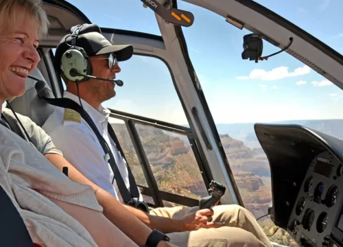 Pilot und Passagier blicken während eines Hubschrauberrundflugs über den Grand Canyon in Arizona auf die Schlucht.